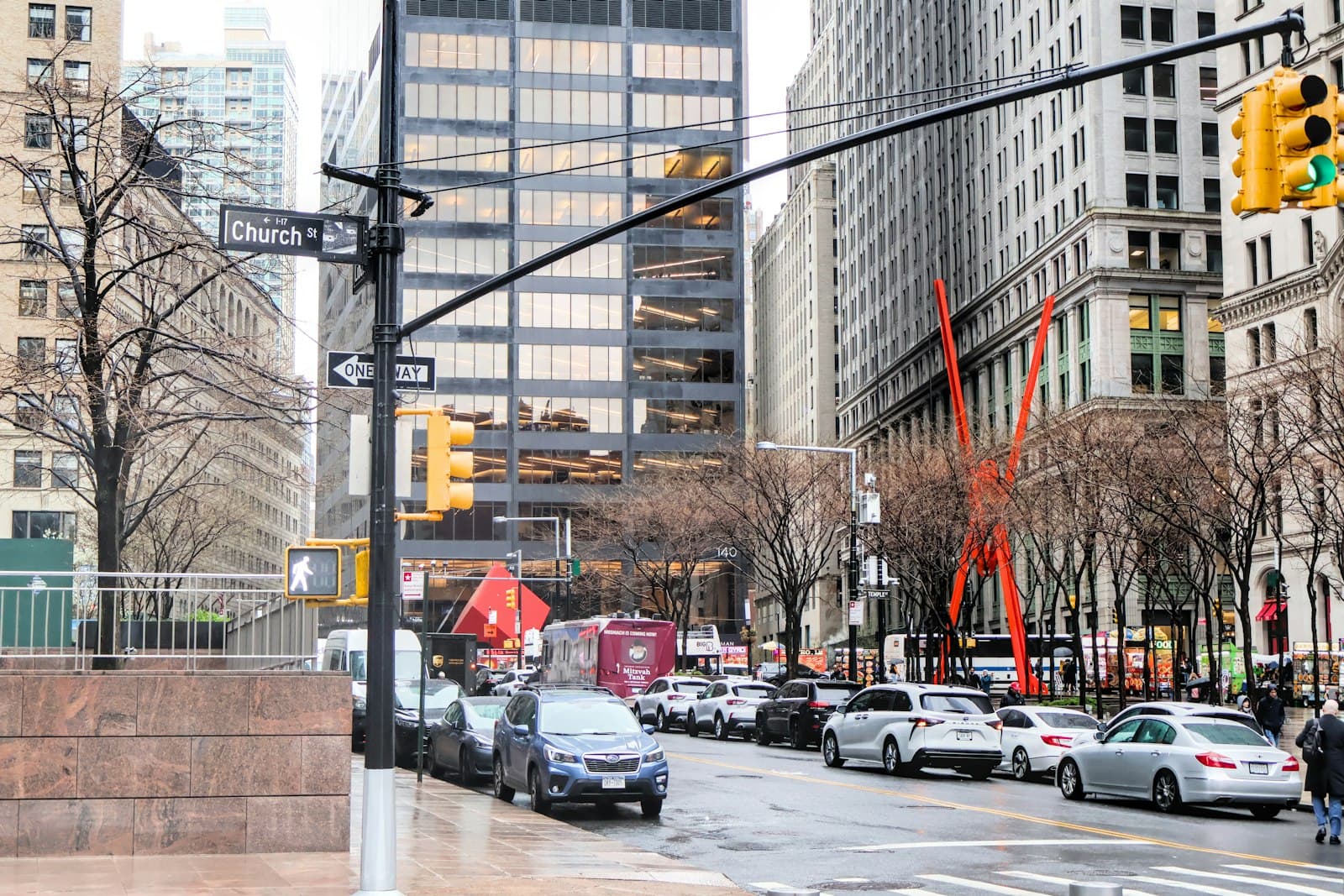 City street lined with tall buildings and traffic