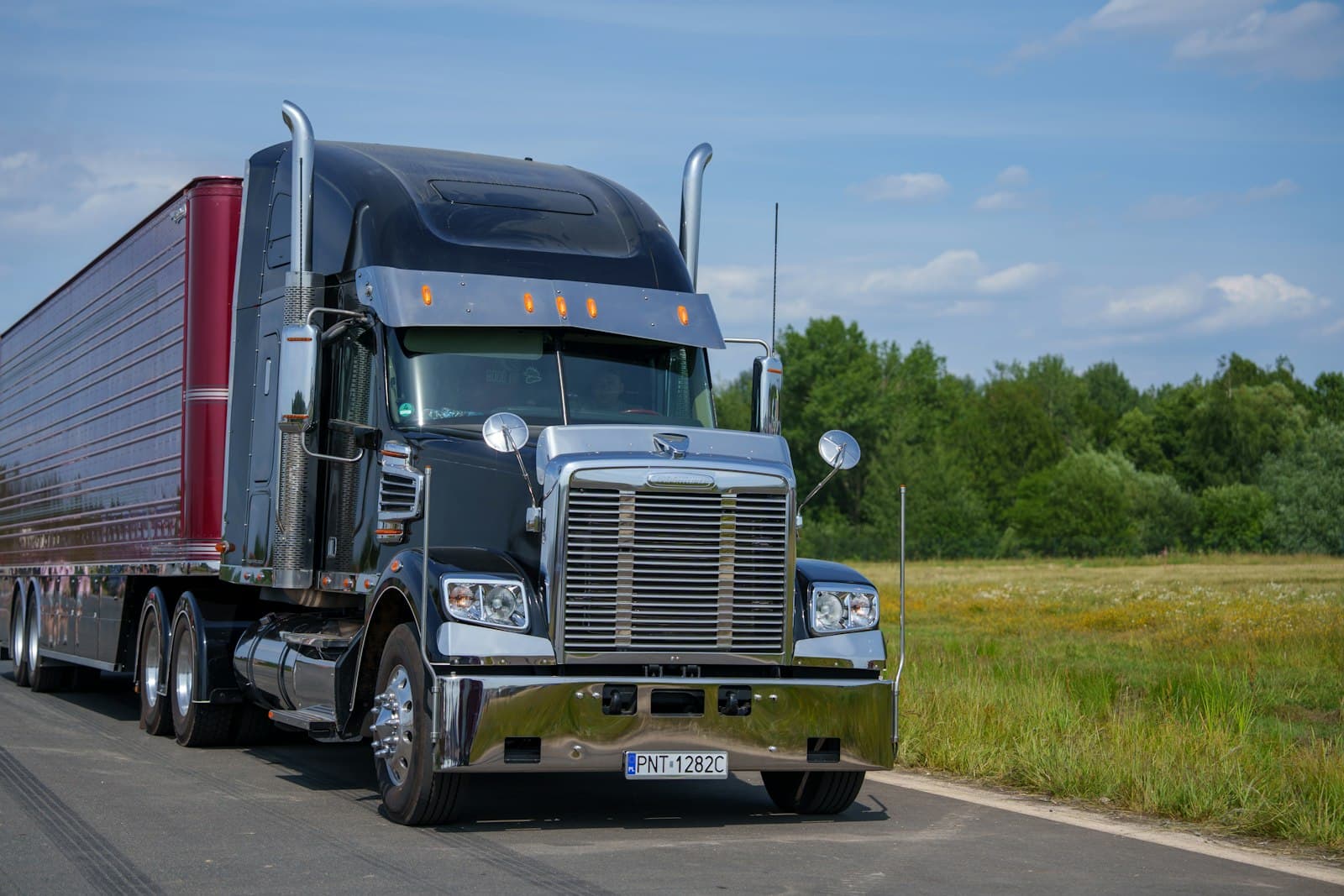 Semi-truck driving down a rural road