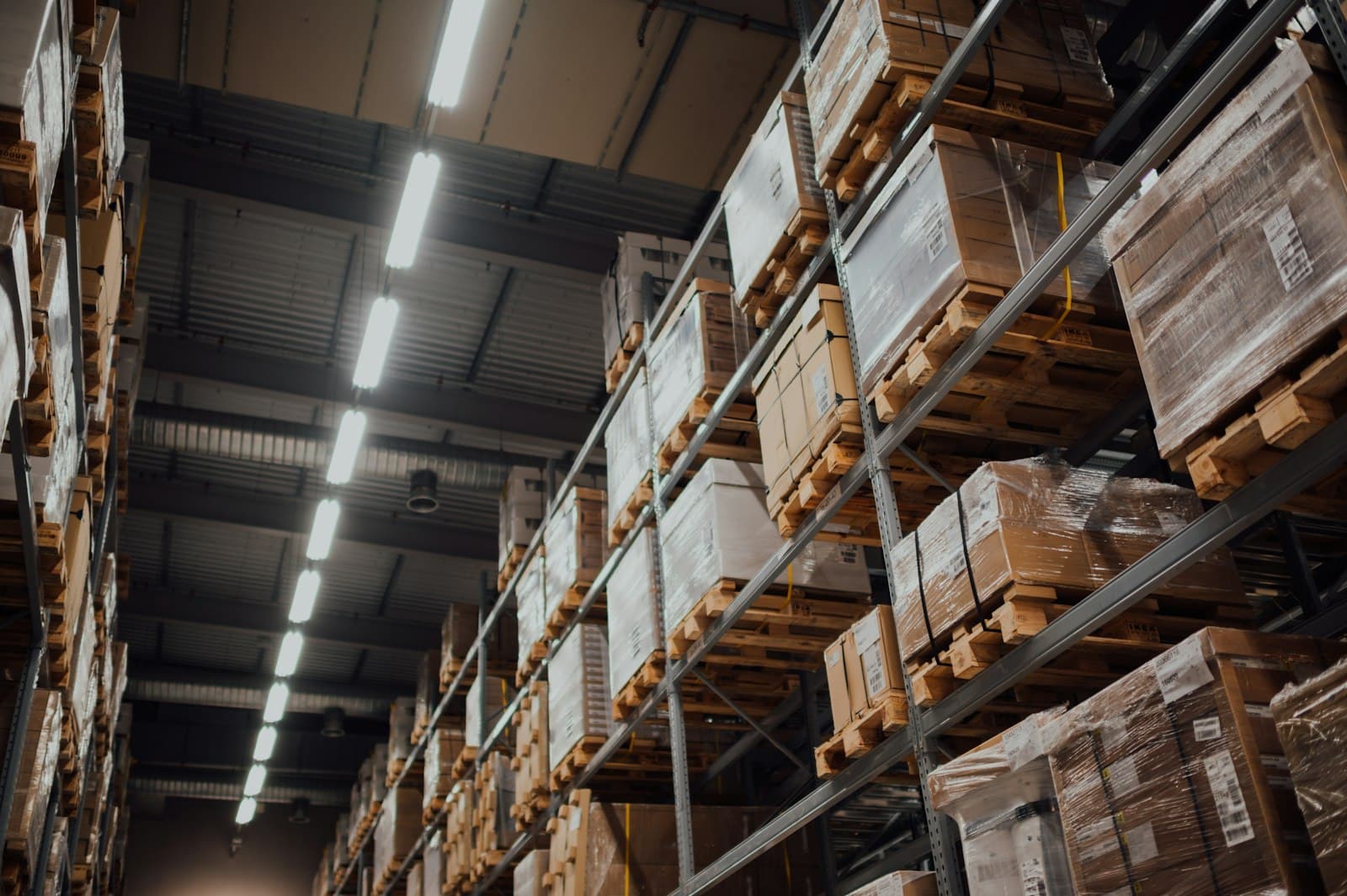 Aisle of a warehouse stacked with pallets