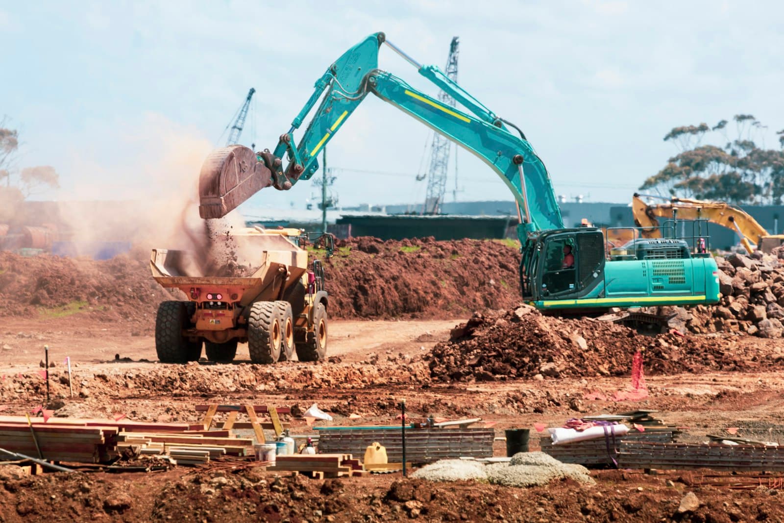 Excavator loading a dump truck at a construction site