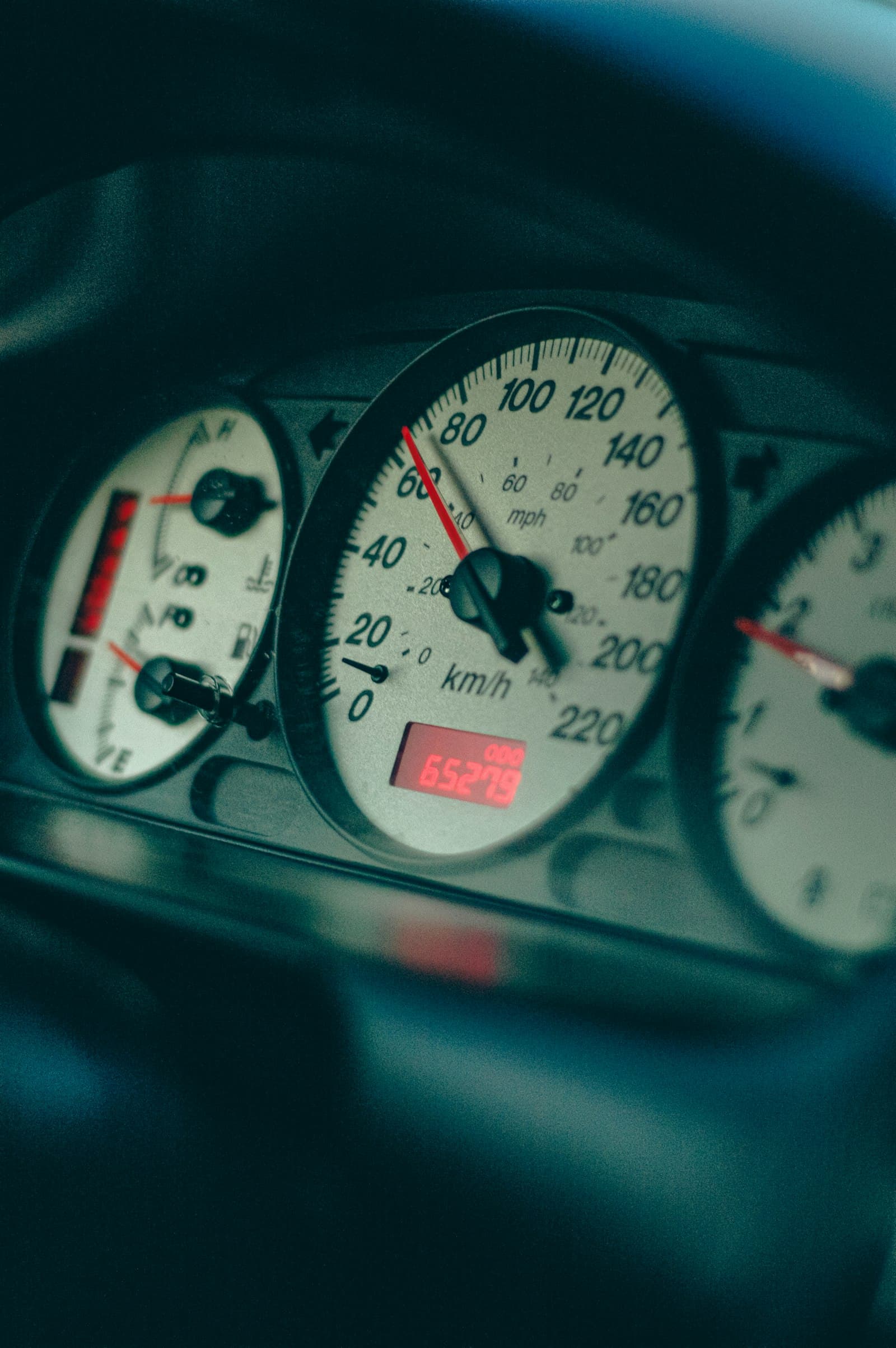 Close-up of a car speedometer with the needle at speed