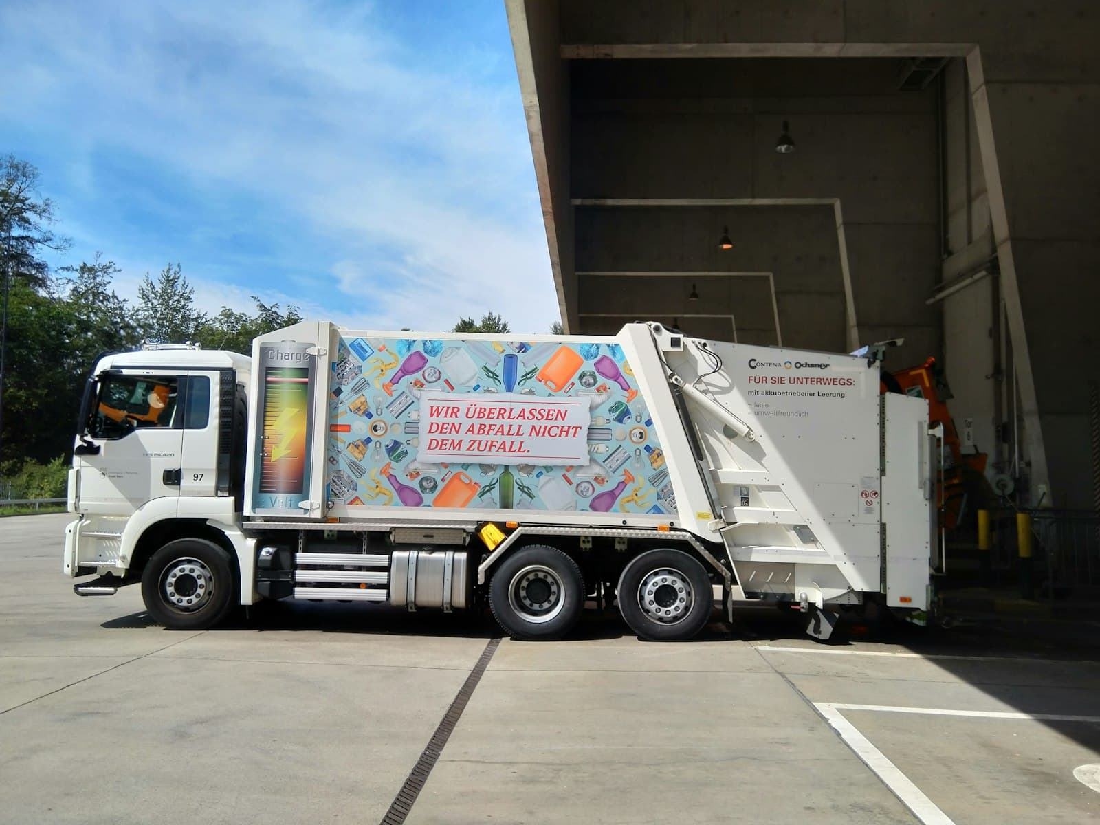 Waste collection truck parked at a depot